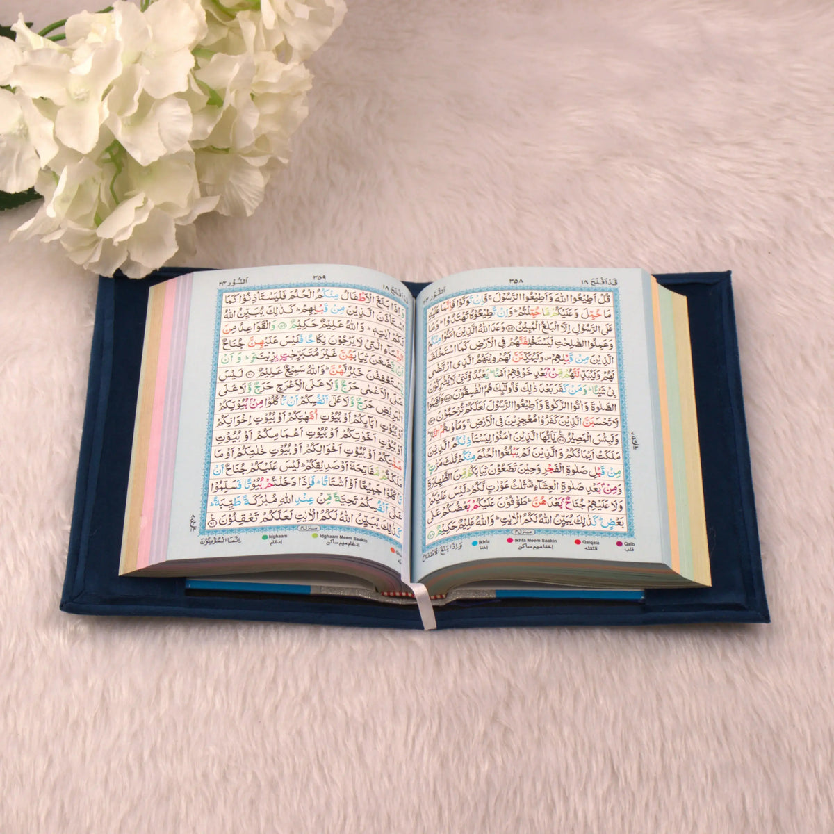Open Holy Quran with colorful page borders from the Blue Sequence Rehal Hamper, ideal for gifting and enhancing spiritual practice.