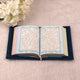Open Holy Quran with colorful page borders from the Blue Sequence Rehal Hamper, ideal for gifting and enhancing spiritual practice.