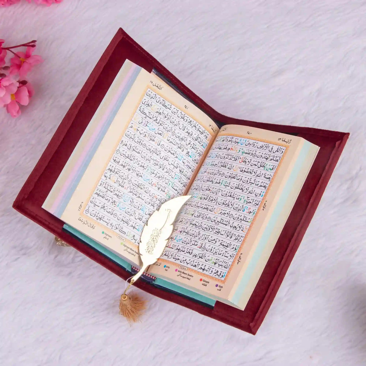 Open book with decorative leaf on a white background