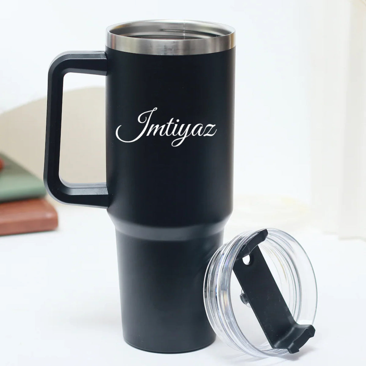 Close-up of black stainless steel tumbler with custom text
