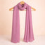 Dark pink studded hijab with smooth chiffon texture, elegantly draped on a wooden hanger. Ideal for versatile modest fashion styling.