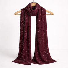 Deep red studded Hijab displayed on a hanger, highlighting its sheer fabric and sparkling stud embellishments.