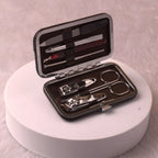 Open personalised travel grooming kit featuring stainless steel nail tools in a brown case. Compact hygiene solution for travel and Umrah.