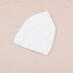 White textured face mask on a beige background