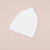 White textured face mask on a beige background