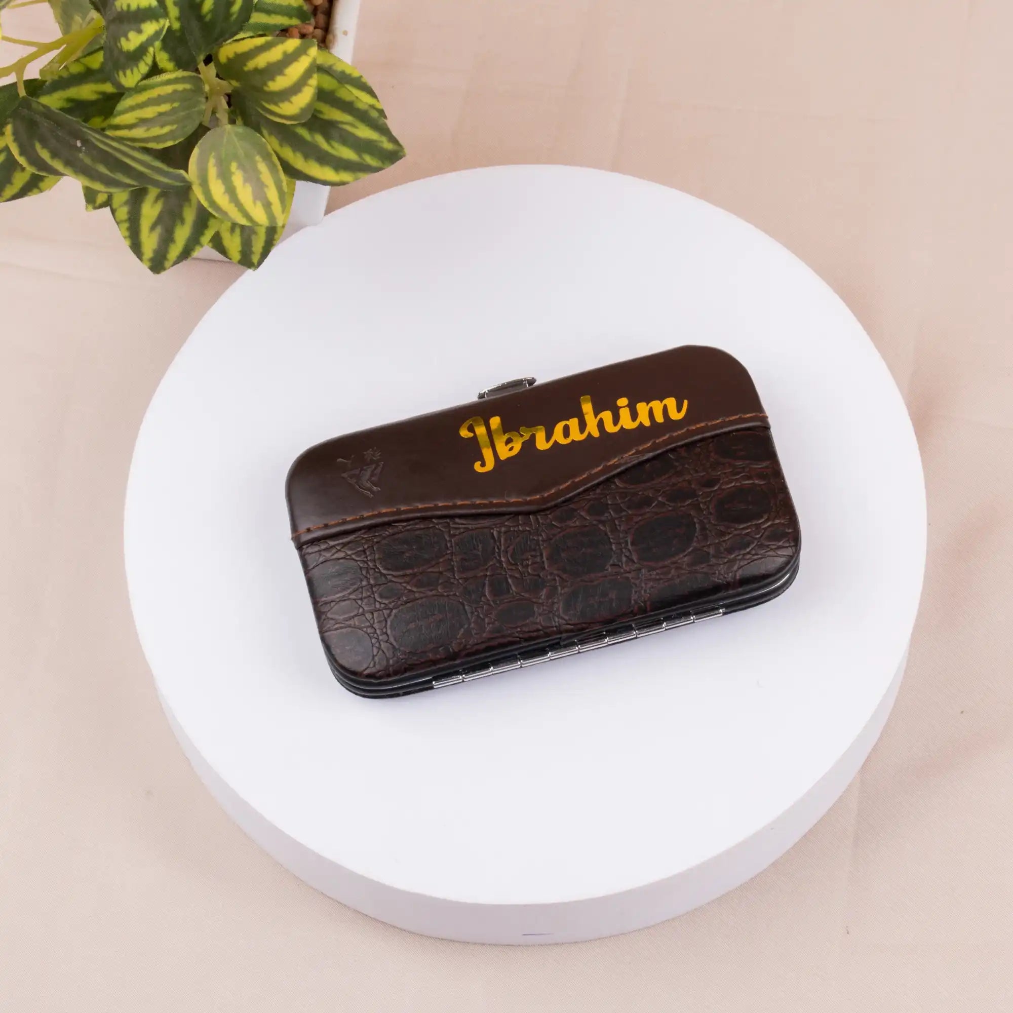 Brown leather case with 'Joraim' branding on a white round platform with a beige background.