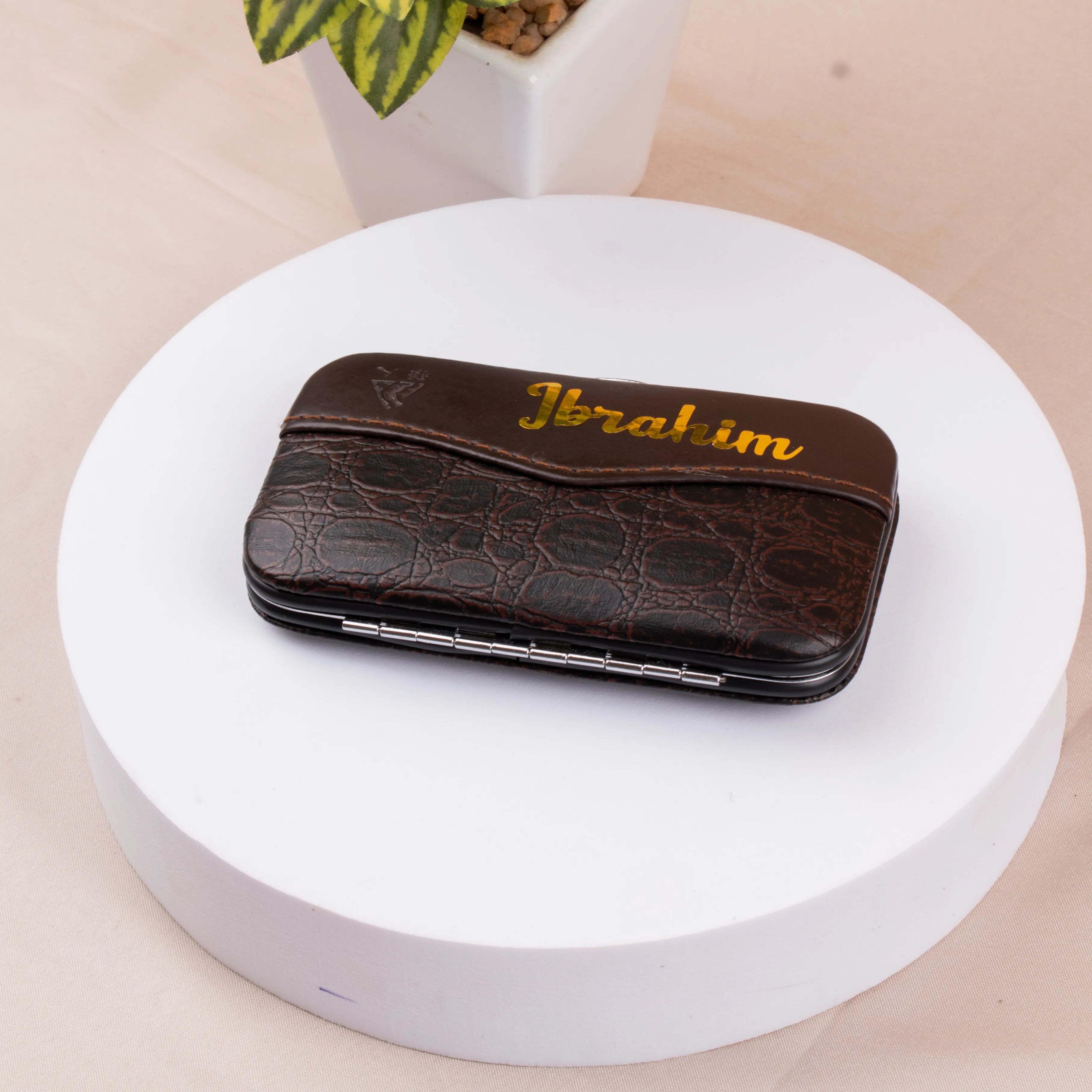 Customised brown leather grooming kit case with gold 'Ibrahim' text. Stylish and practical travel gift for men and women.