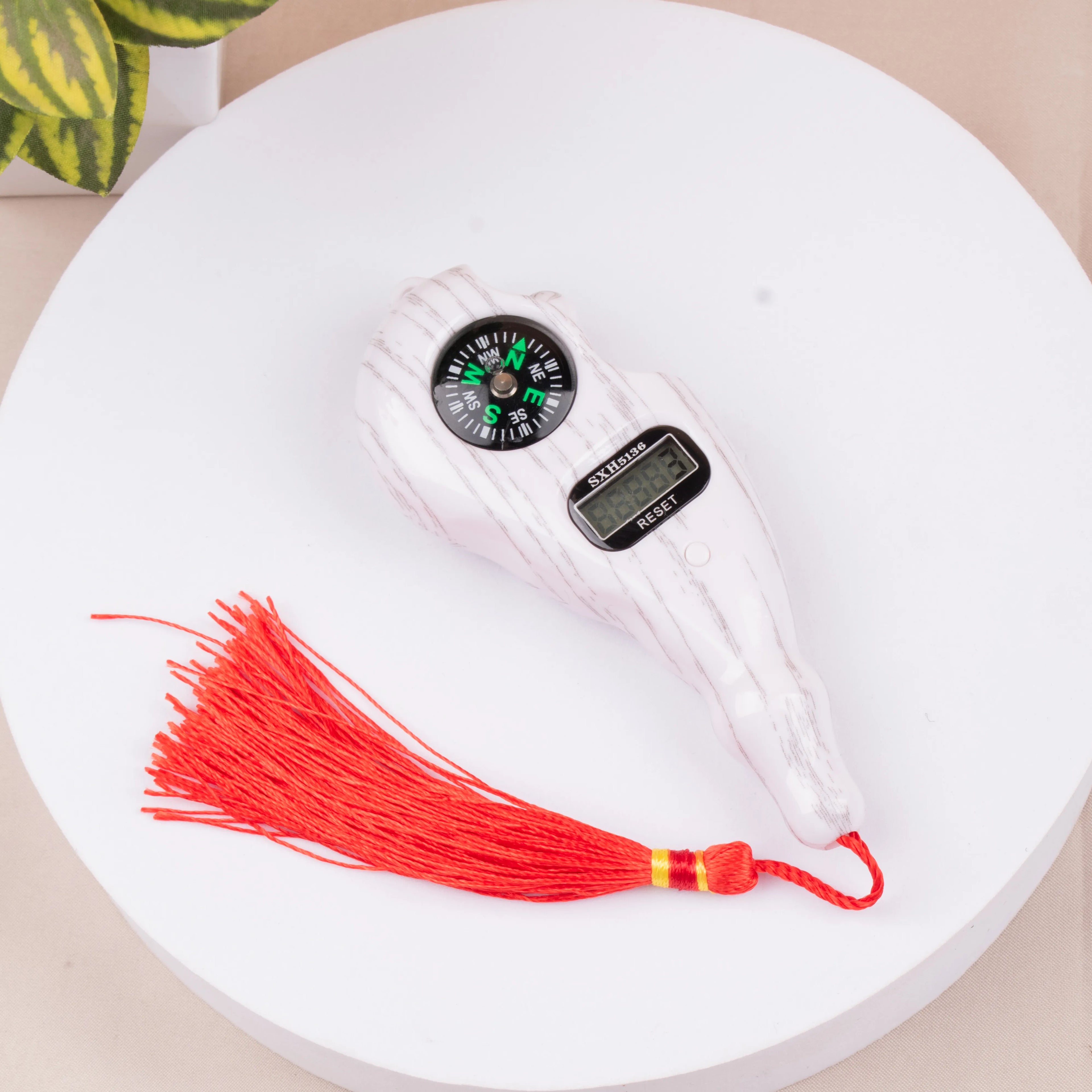 Digital tally counter with compass and red tassel from Raah-e-Makkah Safar Essentials - Luxury Hajj Umrah Hampers for dhikr and direction.