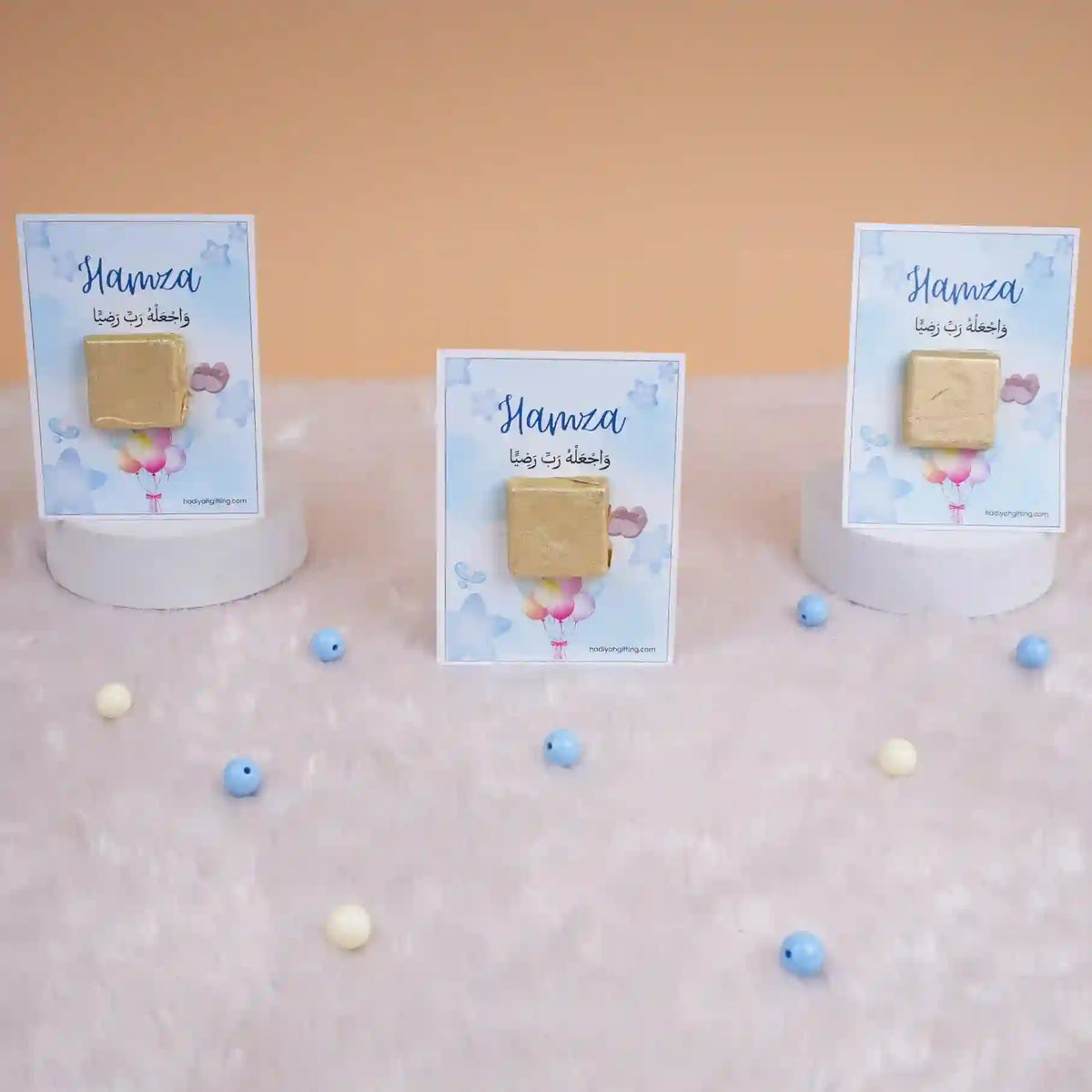 Three Aqiqah Sweet Blessings Favors on display with blue cards and gold chocolates, perfect for Aqiqah party favors for boys.