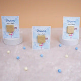 Three Aqiqah Sweet Blessings Favors on display with blue cards and gold chocolates, perfect for Aqiqah party favors for boys.
