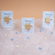 Three Aqiqah Sweet Blessings Favors on display with blue cards and gold chocolates, perfect for Aqiqah party favors for boys.