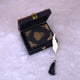 Mini Quran in black velvet with gold detailing, placed inside an open handmade designer box with feather bookmark, perfect for bridal or groom gifts.