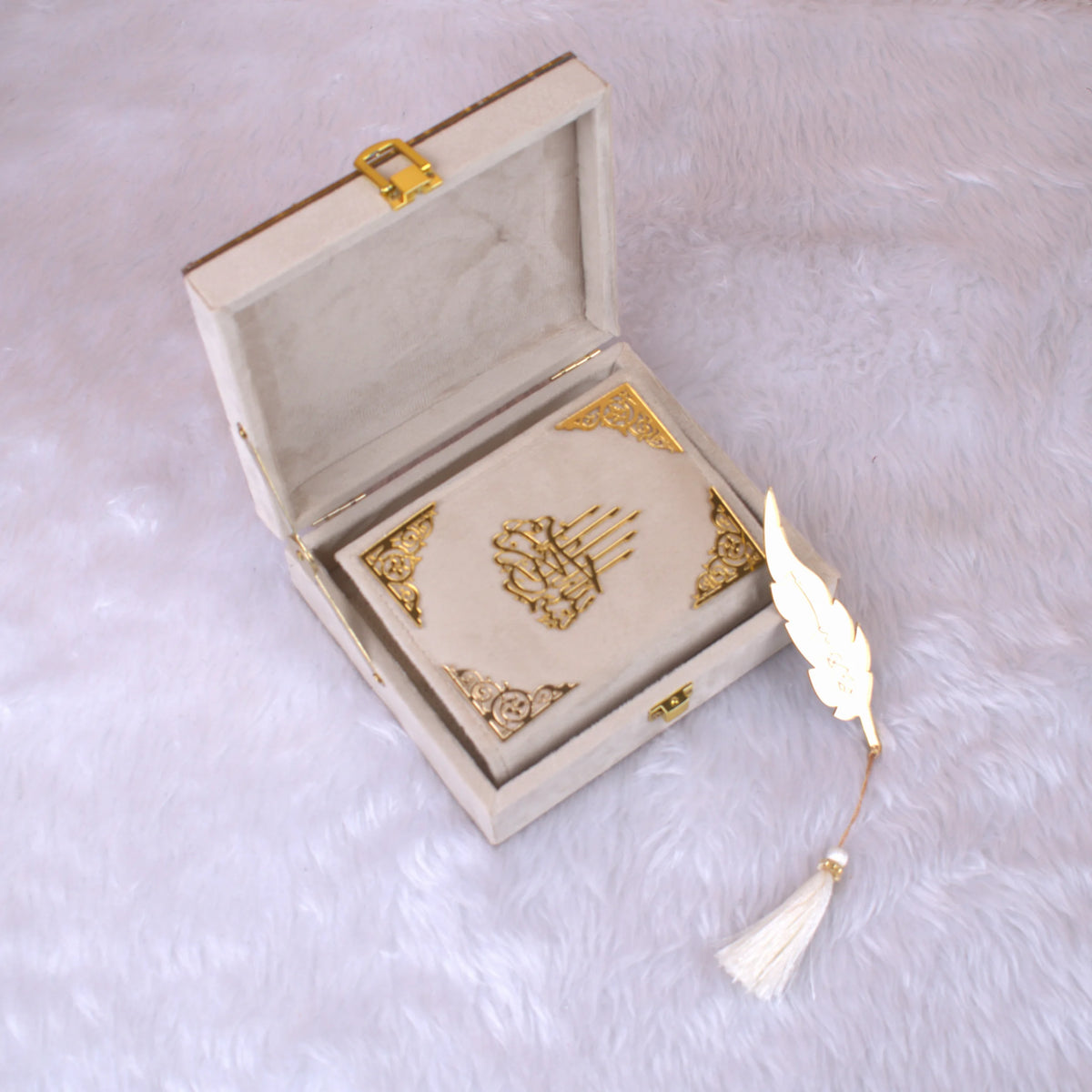 Offwhite Mini Velvet Quran placed inside a plush gift box with gold clasp and feather tassel, perfect for weddings and religious occasions.