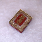 Closed Maroon Mini Velvet Quran Gift Box adorned with pearls and gold Arabic calligraphy. Luxurious religious gift from the Sequence Collection.
