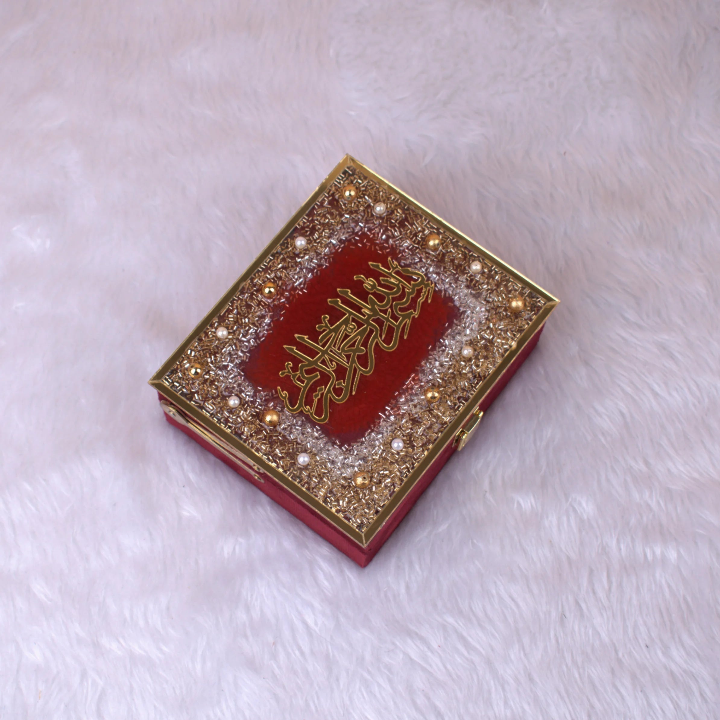 Closed Maroon Mini Velvet Quran Gift Box adorned with pearls and gold Arabic calligraphy. Luxurious religious gift from the Sequence Collection.