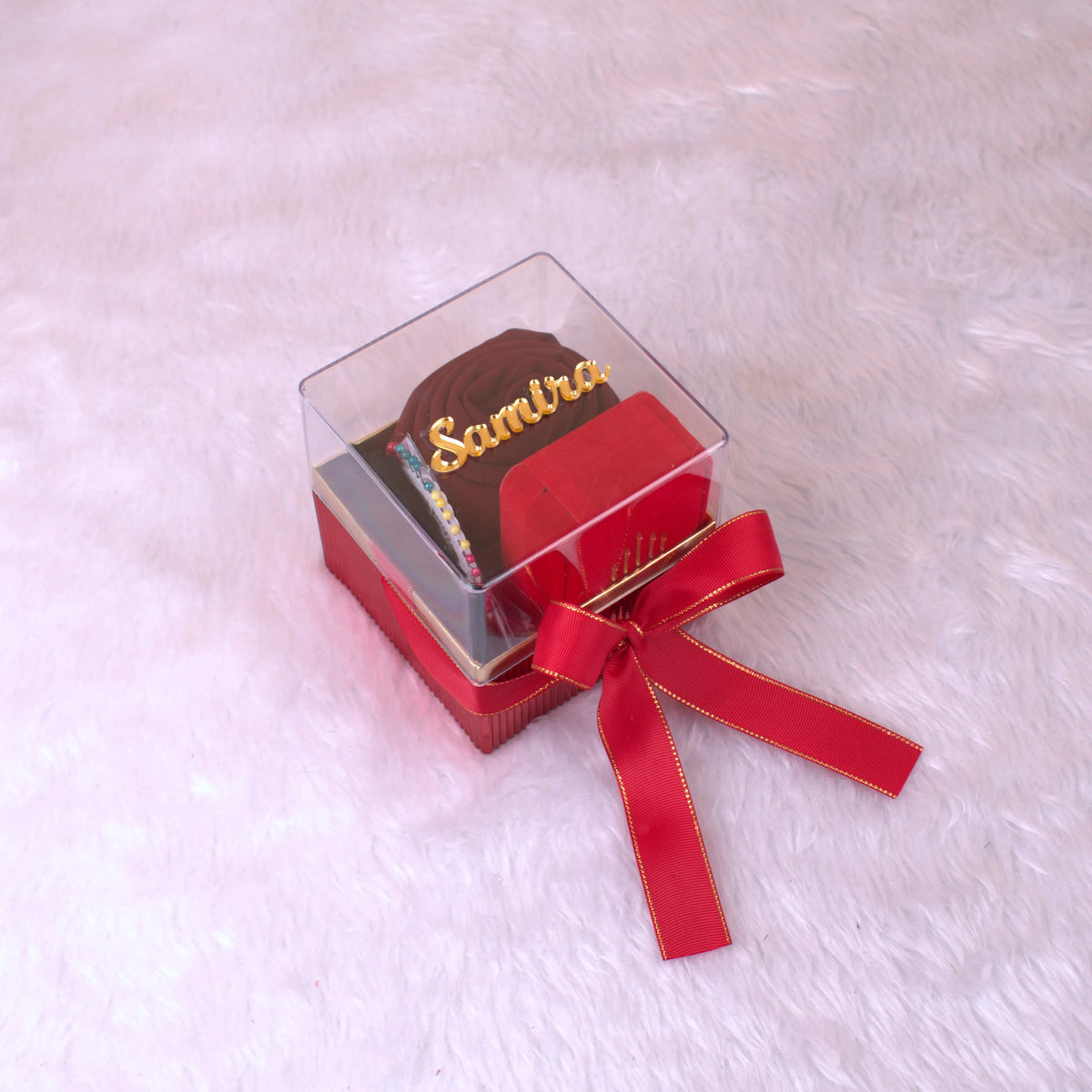 Personalized Red Hijab Combo gift box with chiffon hijab, cap, and accessories, tied with a red ribbon and labeled 'Samira'.