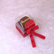 Personalized Red Hijab Combo gift box with chiffon hijab, cap, and accessories, tied with a red ribbon and labeled 'Samira'.