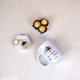 Flat lay of Barakah Blessings Hamper with personalized Hajj Mug, Kaaba keychain, and chocolates. Thoughtful gift for Hajj & Umrah pilgrims.