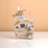 Makkah Moments Hamper packaged in a clear gift bag with ribbon, includes personalized Hajj frame, chocolates, and keychain. Great for gifting.