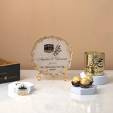 Pilgrim's Promise Hamper - Hajj Gift Hamper featuring gold candle, personalized Hajj frame, chocolates, and Kaaba keychain for Umrah return gifts.
