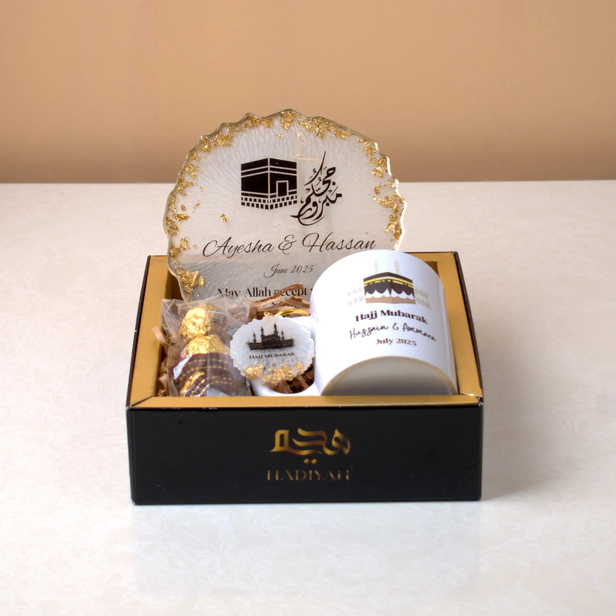 Hearts of Hajj Hamper in Hadiyah Box featuring custom Hajj frame, mug, keychain, and chocolates, perfect for Hajj & Umrah return gifts.