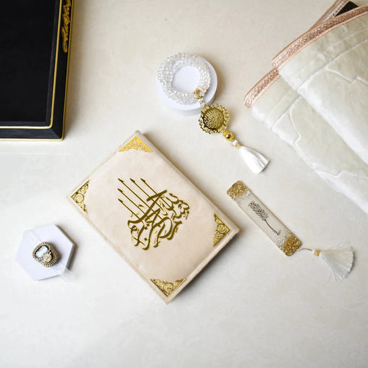 Luxury Islamic gift set featuring Quran, prayer mat, Tasbeeh counters, and elegant accessories on a black velvet tray