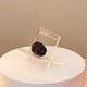 Close-up of Acrylic Date Stand with Bismillah inscription, showcasing a single date for Ramadan, ideal for kitchen and dining decor.