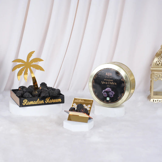 Premium Ajwa dates in decorative black and gold box, Ramadan celebration setup