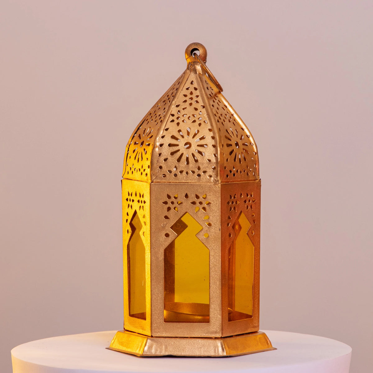 Gold-toned Golden Glow Ramadan Lantern with intricate cutouts and yellow glass, 6-inch decor piece for festive ambiance and luxury interiors.