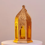 Gold-toned Golden Glow Ramadan Lantern with intricate cutouts and yellow glass, 6-inch decor piece for festive ambiance and luxury interiors.