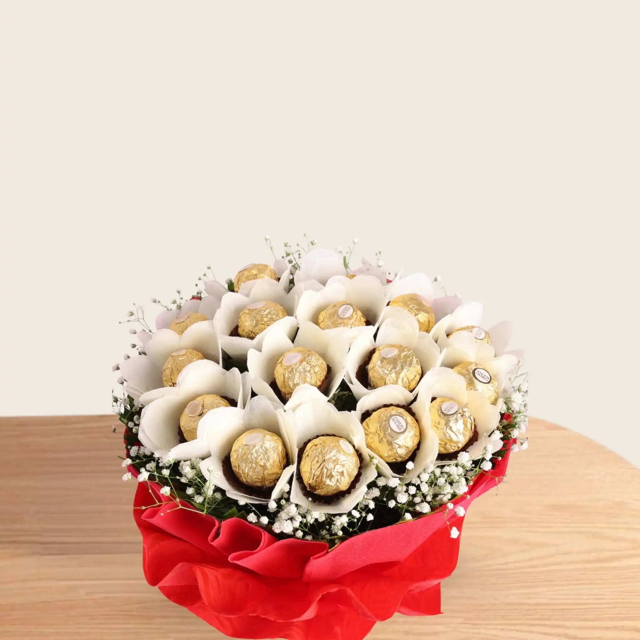 Ferrero Rocher Bunch - Chocolate Bouquet | 16 Piece Pack arranged in white paper flowers with green fillers, wrapped in red paper and white ribbon.