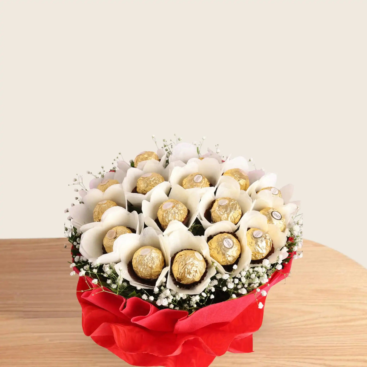 Ferrero Rocher Bunch - Chocolate Bouquet | 16 Piece Pack arranged in white paper flowers with green fillers, wrapped in red paper and white ribbon.