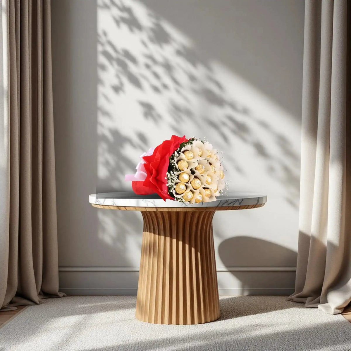 Ferrero Rocher Bunch - Chocolate Bouquet | 16 Piece Pack arranged in red and white wrapping with green fillers and white ribbon on a marble table.