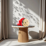 Ferrero Rocher Bunch - Chocolate Bouquet | 16 Piece Pack arranged in red and white wrapping with green fillers and white ribbon on a marble table.