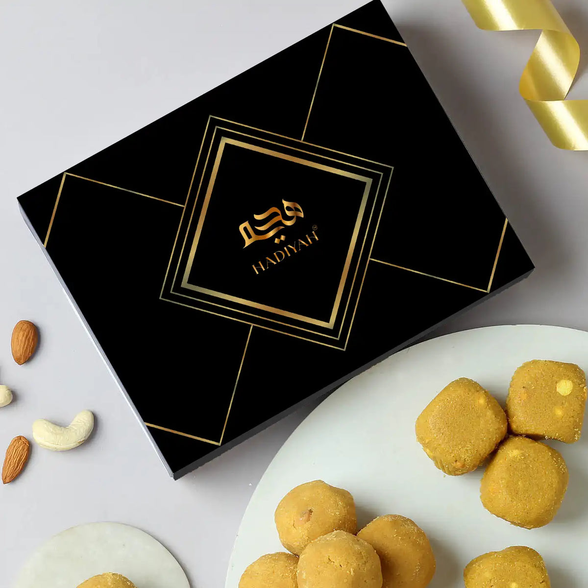 Desi Ghee Besan Laddoo - Authentic Sweets | 200gms & 400gms in elegant black gift box with golden accents, ideal for festive gifting.