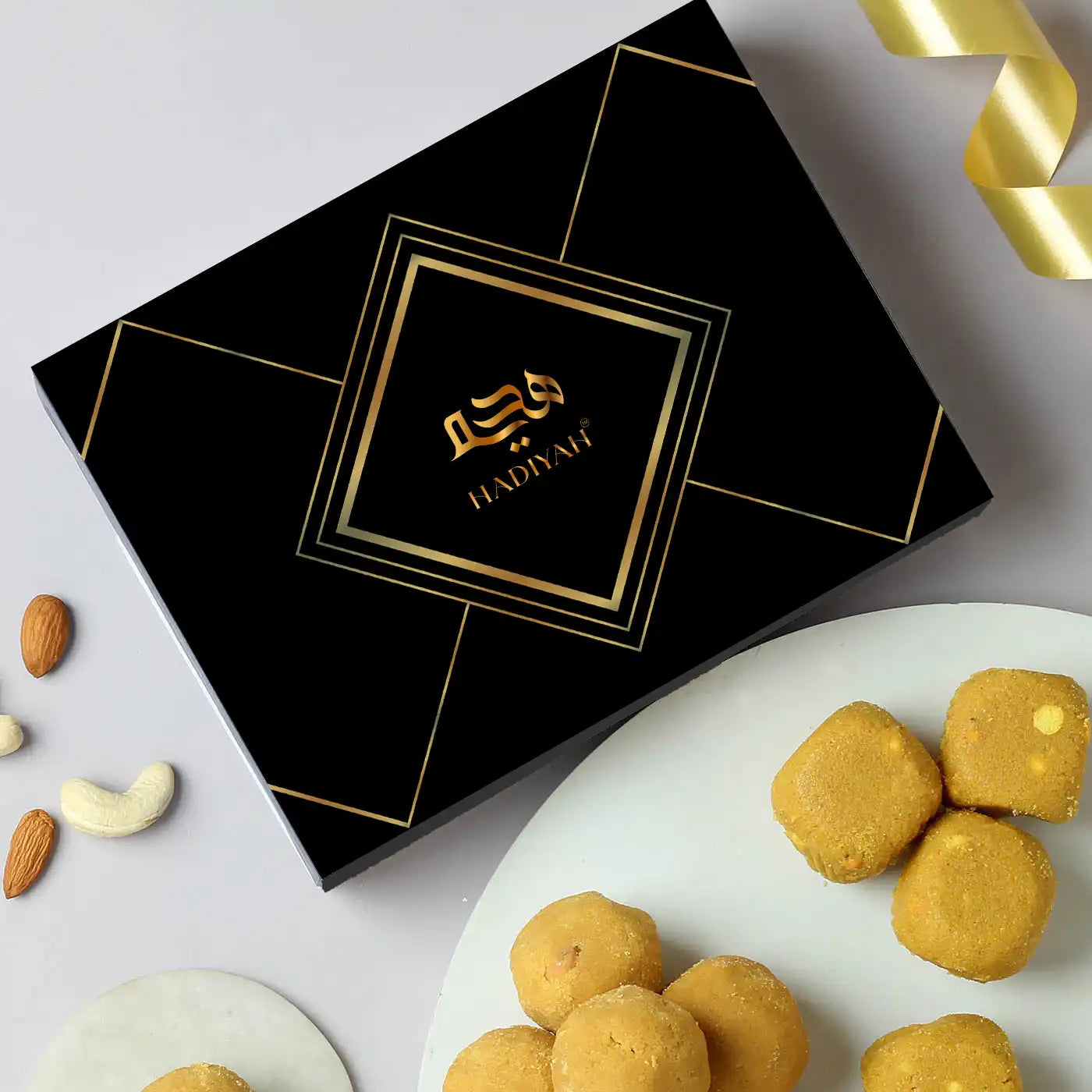 Desi Ghee Besan Laddoo - Authentic Sweets | 200gms & 400gms in elegant black gift box with golden accents, ideal for festive gifting. Main image