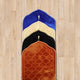 Stacked Dome Shaped Janamaz in various colors on wooden floor, showcasing variety in premium prayer rug options.