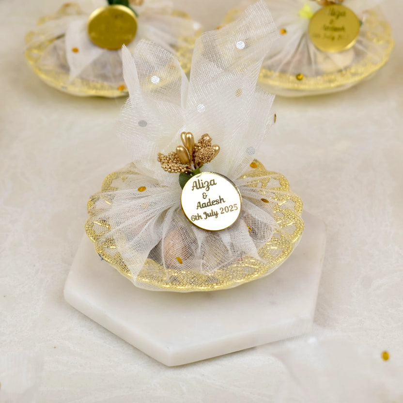 Mix Dry-Fruit Nikah Favor Gift Tray with personalized gold tag, wrapped in white net fabric and decorated with golden accents. Main image