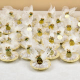 Bulk Mix Dry-Fruit Nikah Favor Gift Trays arranged for a wedding, each wrapped in white mesh with custom gold tags and golden embellishments.