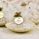 Close-up of Mix Dry-Fruit Nikah Favor Gift Tray featuring a gold tag with names and date, wrapped in elegant white net with gold details.