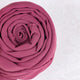 Close-up of a pink fabric roll on a white background