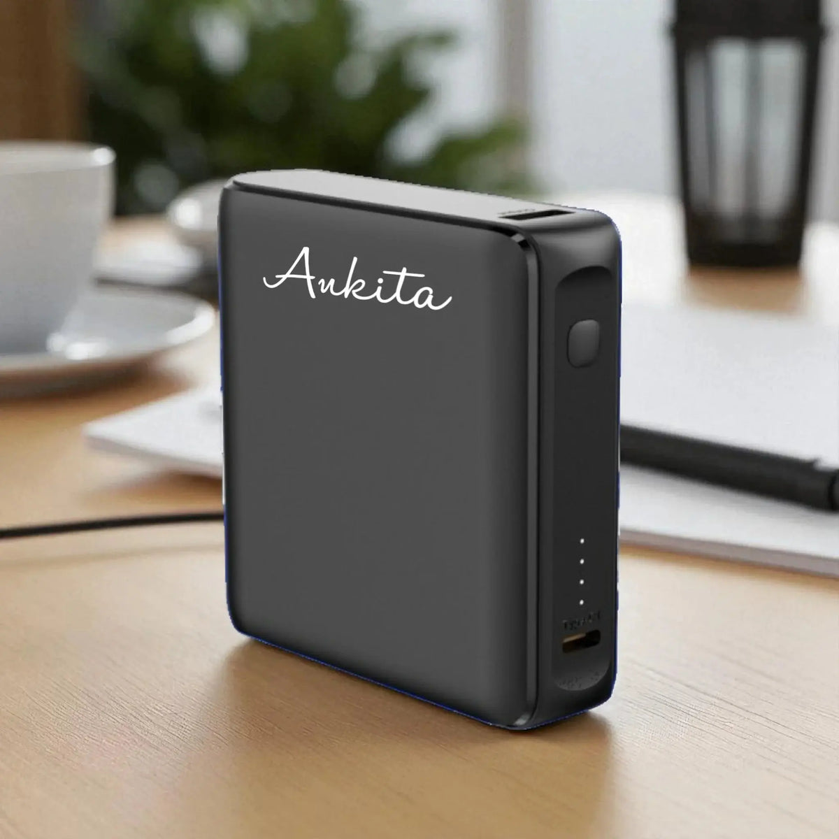 EnFast Ace Pocket Powerbank - 10000mAh Power in matte black with LED indicators and USB port, ideal for portable charging on desks or travel.