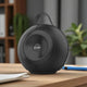 Rear view of EnLumia Bluetooth Speaker showing mesh speaker grille and handle. Sleek black design fits modern audio setups.