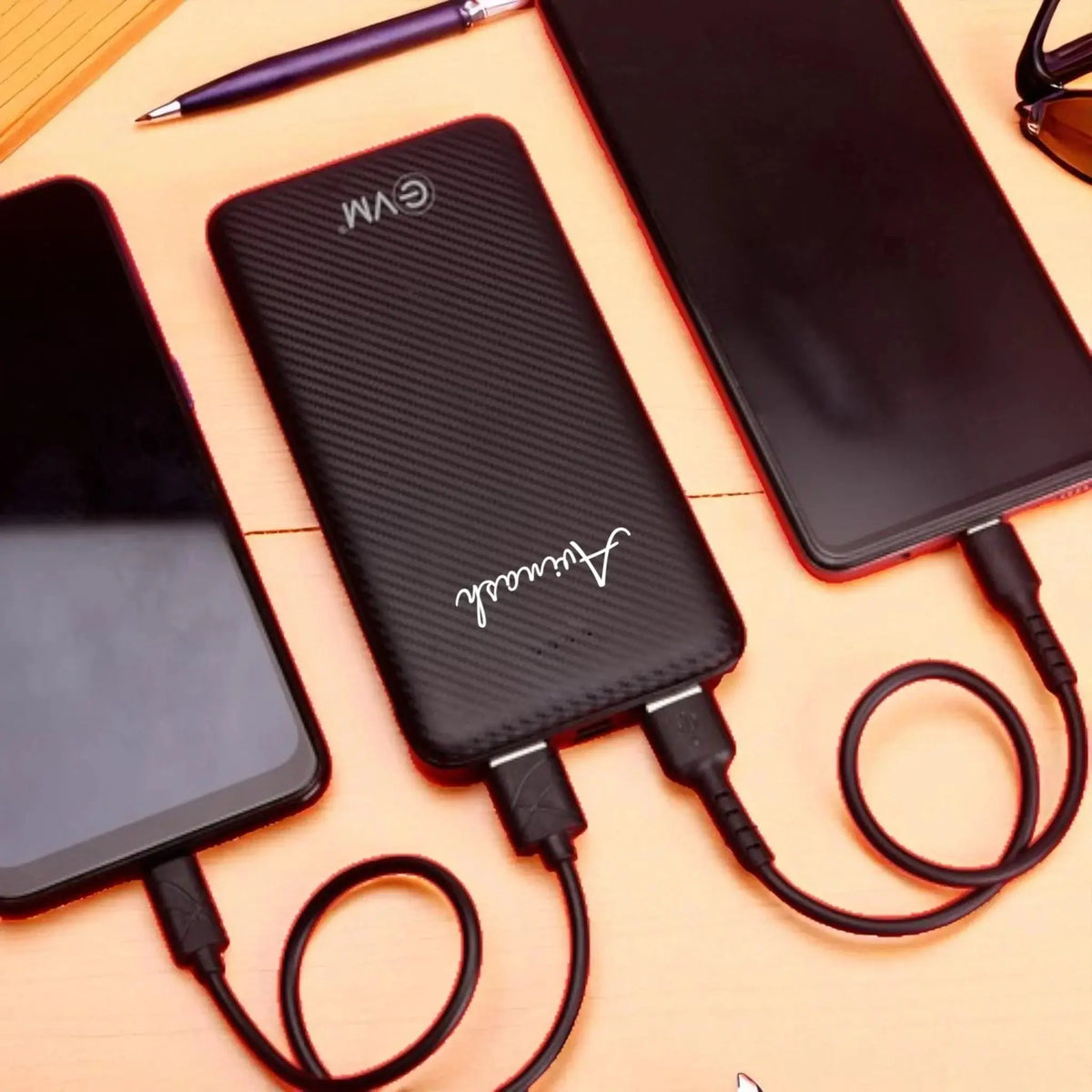 Black EnZest Powerbank 10000mAh charging two smartphones via dual USB ports, ideal for multitasking on the go.