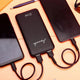 Black EnZest Powerbank 10000mAh charging two smartphones via dual USB ports, ideal for multitasking on the go.