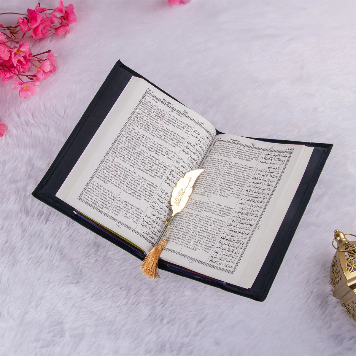 Open Quran with English translation and gold feather bookmark. Featured in the Sawab-e-Jariya Bridal Gift set for diverse gifting.