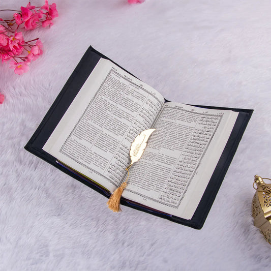 Quran with English translation and golden feather bookmark from the Black Sequence Rehal Hamper - ideal for global gifting.