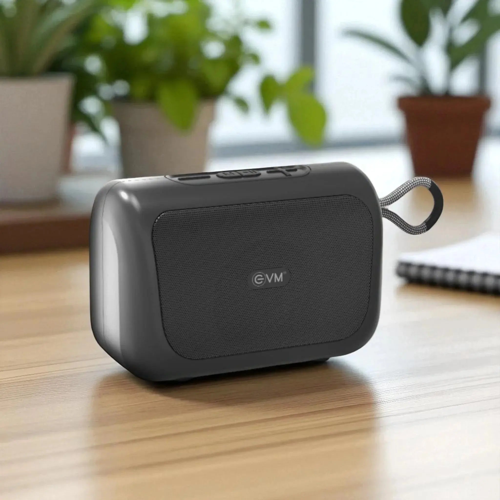 Bluetooth Speaker EnVox in sleek black design on a wooden desk, showcasing deep sound and strong connectivity for home or office use. Main image