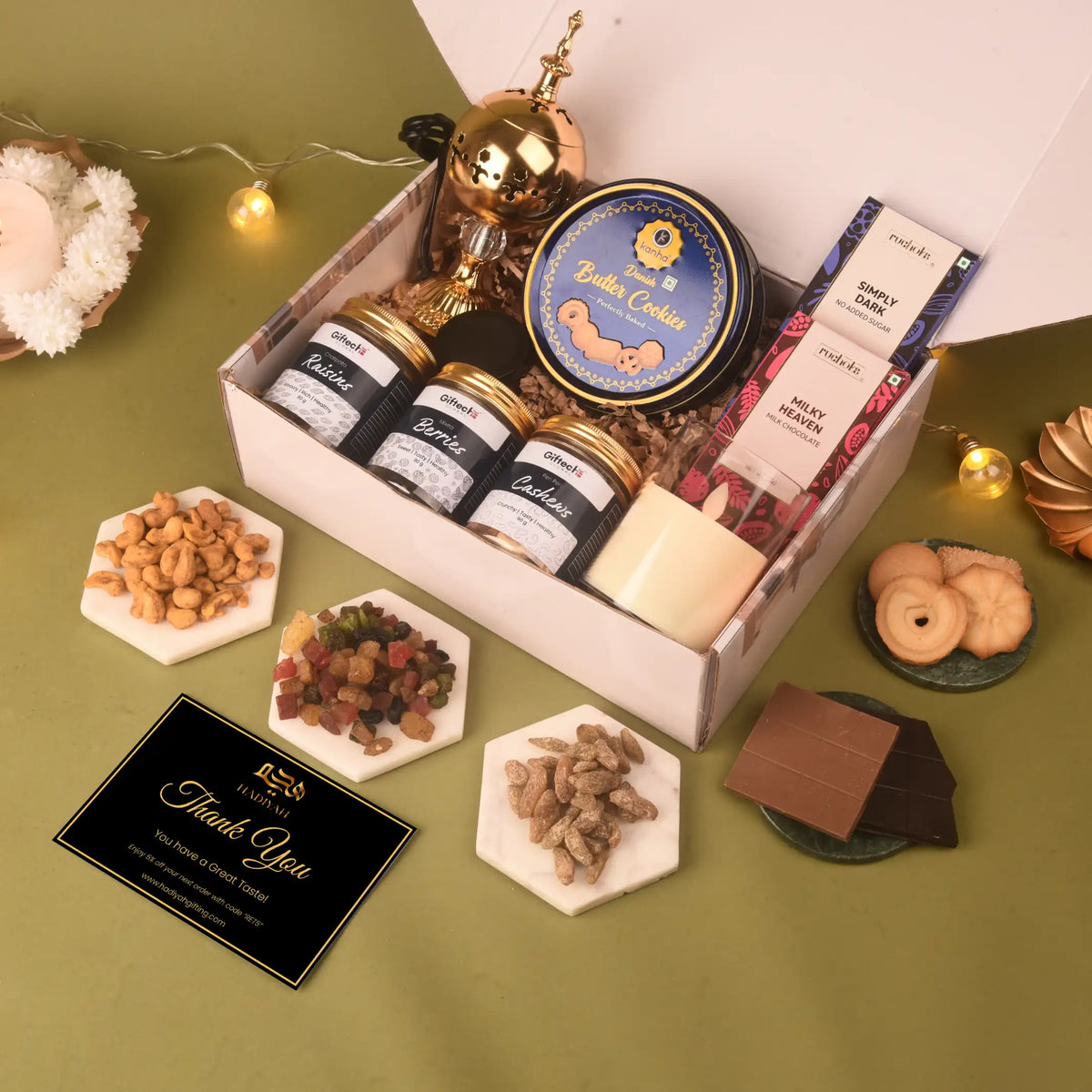 Open Shaan-e-Noor Hamper displaying butter cookies, chocolates, dry fruits, and a thank you card, ideal for gifting during festive occasions.