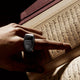 Black Smart Zikr Ring Flex Pro used during Quran recitation, designed for seamless zikr and prayer support.